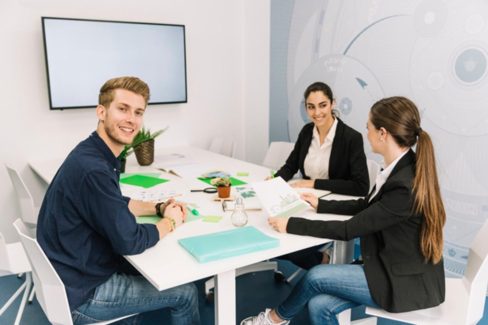 Business partners reviewing financial documents in modern office setting